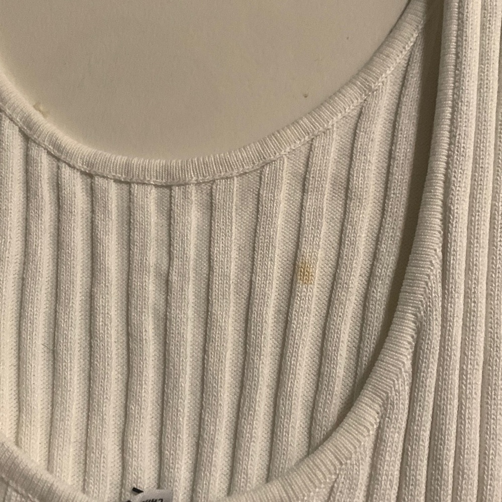 Pretty white dress just a small stain on it I taking a picture of it